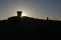 Sun flare from behind toposcope at worcestershire beacon at sunrise Royalty Free Stock Photo