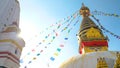 SUN FLARE: Breathtaking view of ropes full of flags hanging off the top of stupa Royalty Free Stock Photo