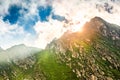 Sun flare bursting behind a mountain peak