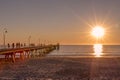 People walking on the jetty to see sunset, Glenelg beach, South Australia