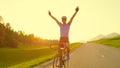 SUN FLARE: Pro cyclist cheerfully rides road bike with no hands after victory.