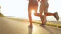 SUN FLARE Young unrecognizable woman and man go for a lovely run along the ocean