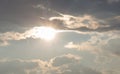 Sun Flaring Through Dark Clouds Royalty Free Stock Photo