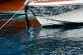 Sun glare on glossy board boats, azure water, tranquillity in port Hercules, bows of moored boats at sunny day