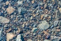 Sun glare on surface water and smooth stones at bottom stream, background. Transparent water in river with rocky bottom Royalty Free Stock Photo