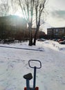 Sun glare in winter in a residential area with cars and snow Royalty Free Stock Photo