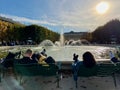 People lounge in front of the fountain in the Palais Royal garden, Paris, France