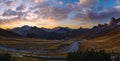 Sun glow in evening hazy sky. Mountain panoramic peaceful view from Giau Pass