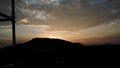 Sun is going down behind a hill. Royalty Free Stock Photo