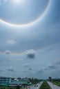 Sun halo in blue sky with cloud