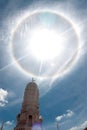 Sun halo or corona phenomenon in cloudy and blue the sky. Royalty Free Stock Photo