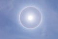 Stunning sun halo with deep blue sky on sunny day Royalty Free Stock Photo