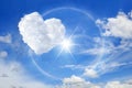Sun halo with heart cloud on the blue sky, Cloud shaped heart on blue sky white cloud background Royalty Free Stock Photo