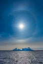 Sun Halo shining over the blue iceberg and ocean, North Greenland