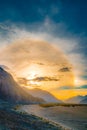 Sun halo during sunset in Ladakh with high mountains and river, India