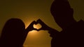 Sun in hand. teamwork of a loving couple. couple in love shows heart symbol with hands. Bride and groom making a heart Royalty Free Stock Photo