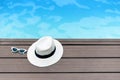 Sun hat and sunglasses on a wooden pier view. Royalty Free Stock Photo