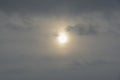 The sun hid behind the gray clouds on gloomy day Royalty Free Stock Photo