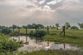 Sun hidden in clouds and reflection in water in countryside hill in Pune, Maharashtra India