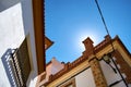 Sun hiding behind the chimney in the roof of a typical Andalusian house.