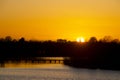 The sun hits the old water tower on the horizon and lights it up