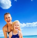 Happy young mother and daughter on seacoast having fun time Royalty Free Stock Photo