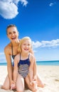 Happy young mother and daughter on seacoast having fun time Royalty Free Stock Photo