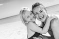 Smiling healthy mother and daughter on seashore embracing Royalty Free Stock Photo