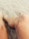 Sun-kissed legs closeup at the beach Royalty Free Stock Photo