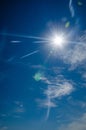 Sun with lens flare, on blue sky background. Royalty Free Stock Photo