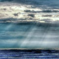 Sun light across clouds from the beach