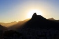 Sun light behind Mountain Corcovado Christ the Redeemer, sunset, Rio de Janeiro