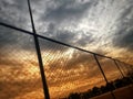 Sun light from clouds passing through fence