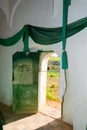 Sun light coming through an old door entrance of an islamic mausoleum