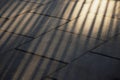 Sun light line on block of grey pavement cement in dark lonely e