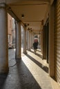 Sun under narrow covered walkway, Mantua, Italy