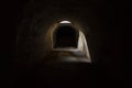 Sun-lit exit from the dark black underground passage at Fort Pospelova on the Russian island