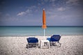 Sun lounger and umbrella on empty beach Royalty Free Stock Photo