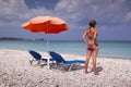 Sun lounger and umbrella on empty sandy beach Royalty Free Stock Photo