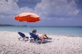 Sun lounger and umbrella on empty sandy beach Royalty Free Stock Photo