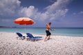 Sun lounger and umbrella on empty sandy beach Royalty Free Stock Photo