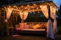 a sun lounger under a gazebo, surrounded by hanging fairy lights