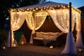 a sun lounger under a gazebo, surrounded by hanging fairy lights