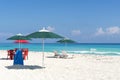 Sun loungers, chairs, table and umbrella on a tropical beach Royalty Free Stock Photo