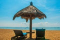 Sun loungers and parasols on the beach. Bali, Indonesia, Tanjung Benoa. Nusa Dua. Royalty Free Stock Photo