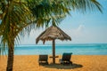 Sun loungers and parasols on the beach. Bali, Indonesia, Tanjung Benoa. Nusa Dua. Royalty Free Stock Photo