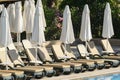 Sun loungers and parasols by pool