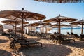 Sun loungers and parasols on the sandy beach Royalty Free Stock Photo