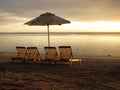 Sun loungers and parasols on a sandy beach Royalty Free Stock Photo