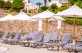 Sun loungers, parasols on the territory of a luxury tropical hotel